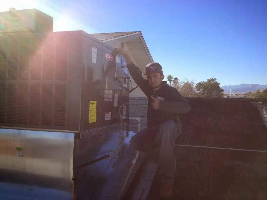 HVAC technician performing HVAC Inspection on a rooftop unit in Easton